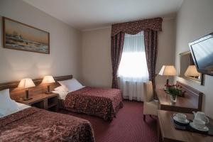 Posteľ alebo postele v izbe v ubytovaní Jasek Premium Hotel Wrocław