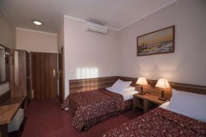 Postel nebo postele na pokoji v ubytování Jasek Premium Hotel Wrocław