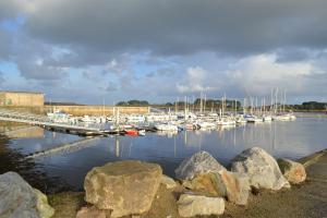 a group of boats docked in a marina with rocks at Le Libenter in Landéda