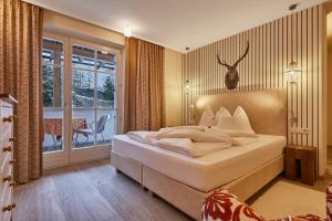 Postel nebo postele na pokoji v ubytování Dolomit Boutique Hotel