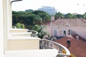 a balcony with a view of a city at Hotel Villa d'Elsa in Juan-les-Pins