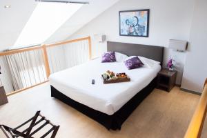 a bedroom with a bed with a tray of fruit on it at Hotel Villa d'Elsa in Juan-les-Pins