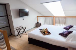 a bedroom with a bed with a tray of fruit on it at Hotel Villa d'Elsa in Juan-les-Pins