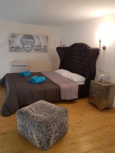 a bedroom with a large bed and a ottoman at Domus Navigli in Milan