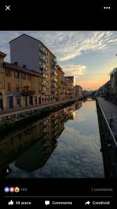 a view of a river in a city with buildings at Domus Navigli in Milan
