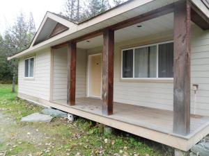 a house with a wooden roof and wooden floors at The Hitching Post Motel in Pemberton