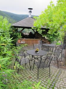 a patio with tables and chairs and a gazebo at Ferienweingut Port in Bernkastel-Kues