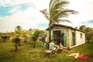 a group of people standing in front of a house at Pousada Cabanas de Búzios in Nísia Floresta