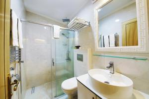 a bathroom with a sink and a shower and a toilet at Katelya Hotel in Istanbul