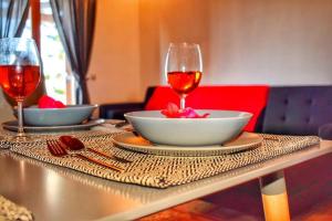 a table with a bowl and a glass of wine at Araucaria House in Skiathos