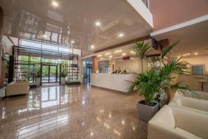 a lobby with a waiting area and plants at Osnabruck Hotel in Tver
