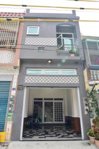 a front view of a house with a balcony at Good Mood Cottage in Hengchun