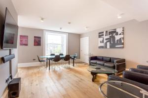 a living room with a couch and a table at ALTIDO Spacious 2BR Apt, moments from West End in Edinburgh