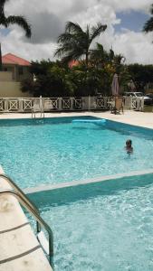 a child swimming in a swimming pool at 1002 Crystal Court Condominiums in Saint James