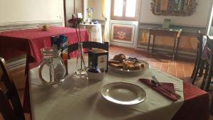 a table with a plate of food on it at Palazzetto Leonardi in San Polo dei Cavalieri +53 photos