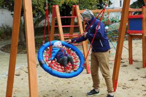 a man playing with a child in a playground at Pałac Bielawa in Bielawa