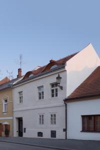 a white building on the side of a street at Stajnhaus in Mikulov