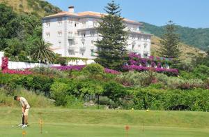 a man playing golf in front of a building at Grand Hotel San Michele in Cetraro
