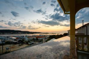 a view from a balcony of a marina at sunset at Apartments Slavko in Supetarska Draga