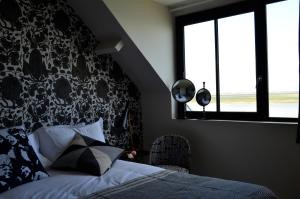 Postel nebo postele na pokoji v ubytování Hotel Les Pilotes