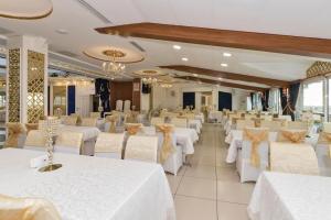 a banquet hall with white tables and chairs at Marnas Hotels in Istanbul