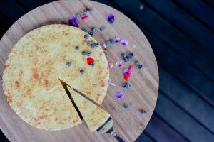 a tortilla sitting on a wooden cutting board with purple beads at Moditlo River Lodge in Hoedspruit