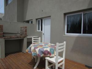 a table and two chairs with a blanket on it at Ñande Roga San Cemente in San Clemente del Tuyú +18 photos