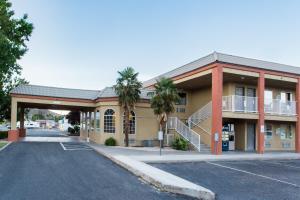 a building with a parking lot in front of it at Hotel Zion Inn, Zion National Park Area in Hurricane
