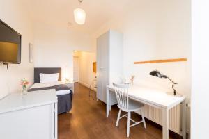 a bedroom with a bed and a desk in a room at 1909 Sigtuna Stads Hotell in Sigtuna