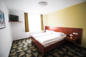 Postel nebo postele na pokoji v ubytování Hotel Der Tannenbaum
