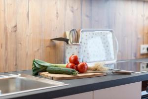 a kitchen counter with vegetables on a cutting board at Appartements Christine in Bezau +42 photos