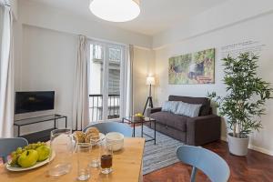 a living room with a table with fruit on it at Downtown Funchal Apartments by An Island Apart in Funchal