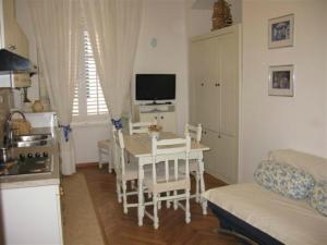 a kitchen and living room with a table and a couch at Apartments Adriana Flora in Dubrovnik