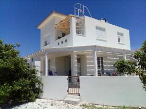 a white house on the beach at Avra Garden Villa in Protaras