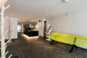 żółtą ławkę w pokoju ze schodami w obiekcie Athens Mosaico Suites & Apartments w Atenach