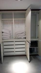 a white closet with white shelves and towels at Shearwaters - Sounds of the sea in Funchal