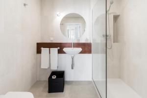 a bathroom with a shower and a sink and a mirror at Downtown Funchal Apartments by An Island Apart in Funchal +146 photos