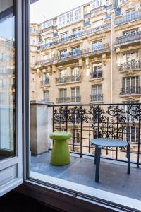 a window with a table and a bench in front of a building at CMG - Suite Premium Tour Eiffel - 51 in Paris