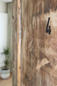 a wooden door with the number on it at Mañana Mañana in Antwerp