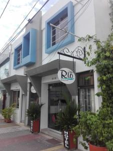 a rio store with a sign on the side of a building at Rio Hotel Montería in Montería