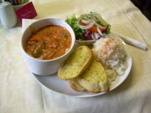 a plate of food with a bowl of soup and a salad at The White Swan in Hunmanby