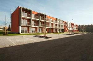 an empty street in front of a large building at Apartmán u Aurory in Třeboň