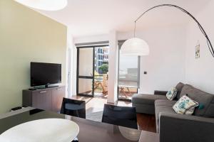 a living room with a couch and a table at Varandas do Funchal I by An Island Apart in Funchal