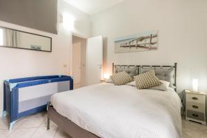 a bedroom with a large bed with white sheets at Casa Sofia -Airport free shuttle-H24 in Bergamo