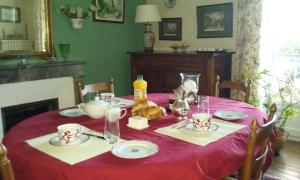 a dining room table with a red table cloth at La Tour de Lavalette in Angoulême