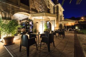 a restaurant with tables and chairs and umbrellas at night at Los Guardeses in Solares