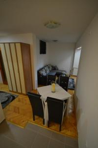 uma sala de estar com uma mesa branca e cadeiras em Apartman Gold em Novi Sad