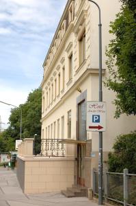 a building with a parking sign in front of it at Hotel An Der Wien in Vienna