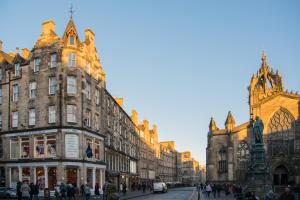 a group of buildings on a street with a church at Royal Mile St Giles St in Edinburgh