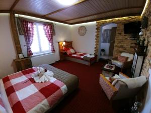 A bed or beds in a room at Privat Gazda Pension